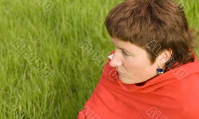  redhead woman sitting on the grass
