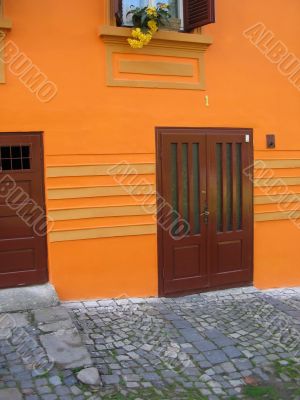 Front door in orange wall.