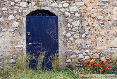 Blue metallic door on stone building