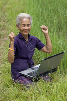 Old Asian with laptop