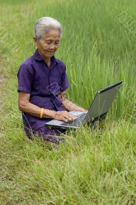 Old Asian with laptop