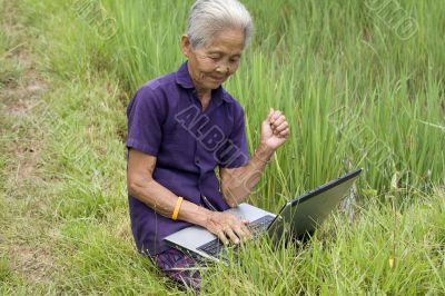 Old Asian with laptop