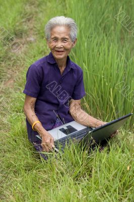Old Asian with laptop