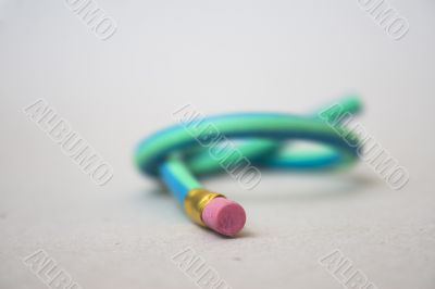 Green rubber pencil twisted into a knot Green rubber pencil twisted into a knot