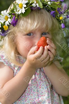 little girl in flowers wreat with strawberries in hands little girl in flowers wreat with strawberries in hands