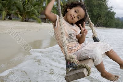Girl on swing at the sea