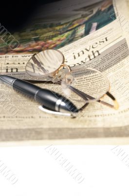 pen and glasses and newspaper