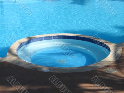 hot tub in a blue outdoor pool