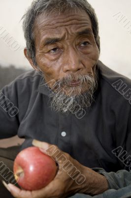 old asian man with apple