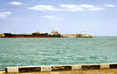 Large transport ship is far from the pier