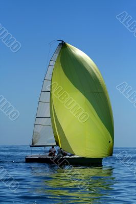 Sailing yaht with spinnaker in the wind