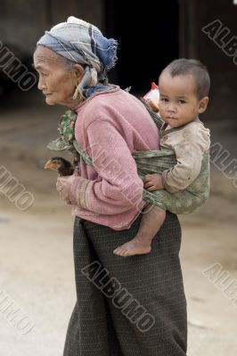 Asia, old woman with chicken and grandson