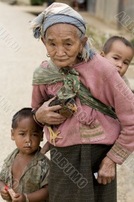 Asia, old woman with chicken and grandson