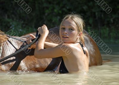 teenager and horse in river