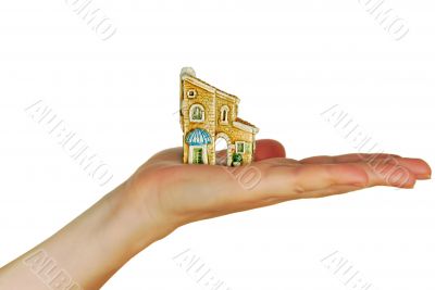 womanish hand holds a toy cottage womanish hand holds a toy cottage
