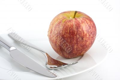 cutlery and an apple