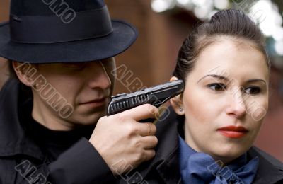 man threatens the woman with gun