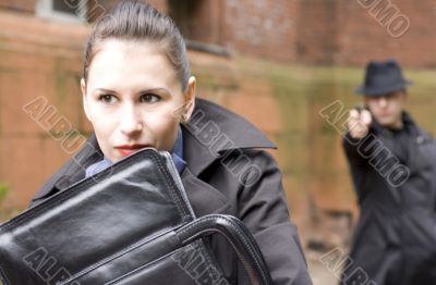 man threatens the woman with a gun