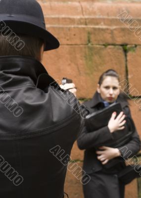 man threatens the woman with gun