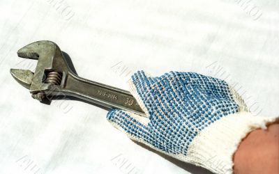 Hand in glove with adjustable spanner