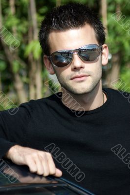 Portrait of a young athletic man with sunglasses