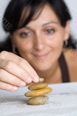 Young woman building balance stones