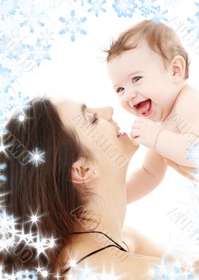 laughing blue-eyed baby playing with mom