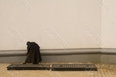 Nun cleaning a wall Nun cleaning a wall