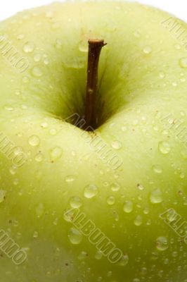 Macro of green delicious apple with reflection