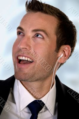 portrait of businessman listening music