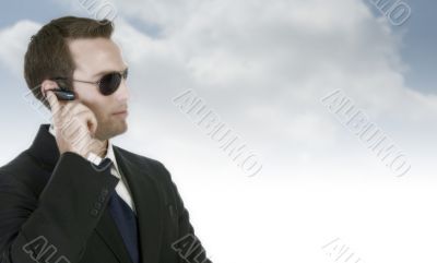 handsome businessman with sunglasses and bluetooth