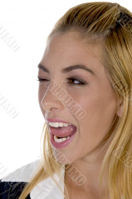 female licking her lips with winked eye
