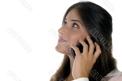 female holding mobile and looking upward