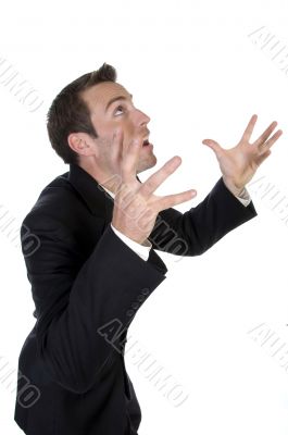 young businessman yelling with raised arms