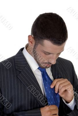 man looking his tie