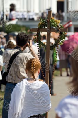 Young girl standing with cross