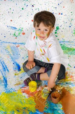 Little boy playing with painting