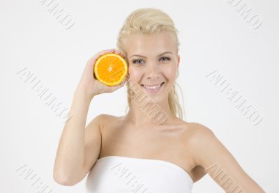waist-up pose of model with slice of orange