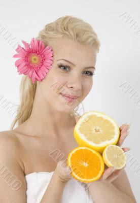 young lady with fruits and pink flower in hair