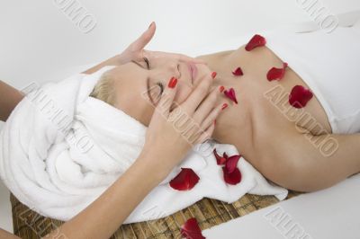 woman receiving face massage from female hands