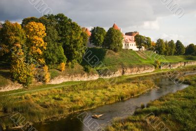 Old castle at river in sunset