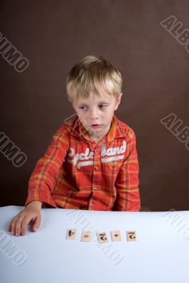 The little boy studies to consider The little boy studies to consider