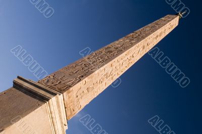 Egyptian obelisk on blue sky