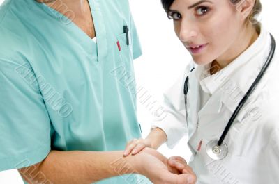 young nurse checking pulse of patient