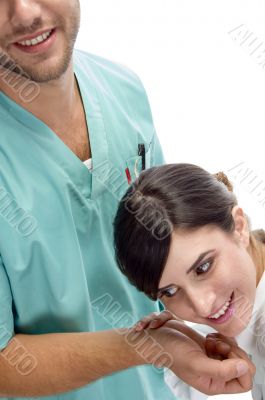 smiling nurse checking pulse of patient