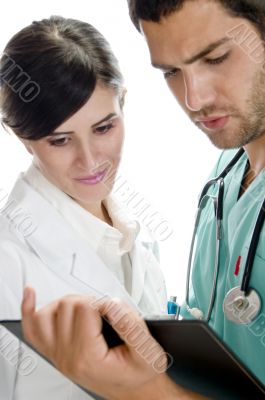 medical professionals looking in writing pad
