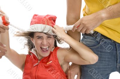 man pulling cap of woman