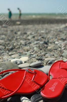 Red footwear on coast on distanc