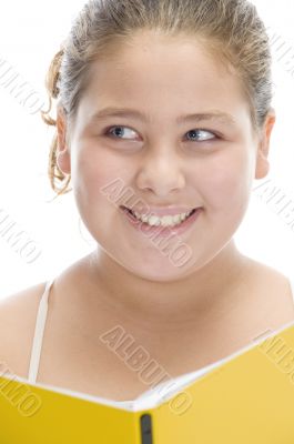 smiling girl with book looking askance