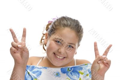 little girl gesturing peace sign